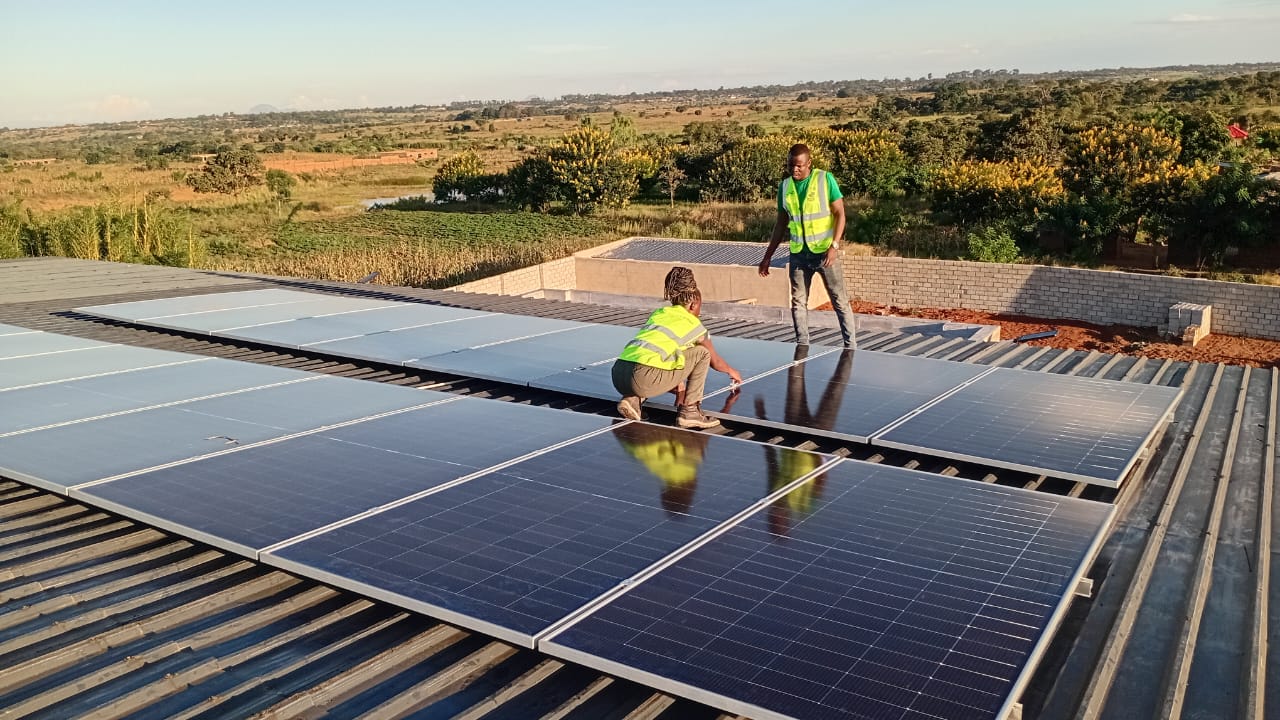 Green Power Systems team fitting solar panels on a commercial rooftop